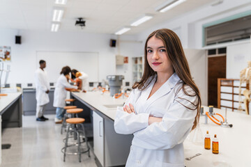 Portrait of confident high school student in science laboratory classroom