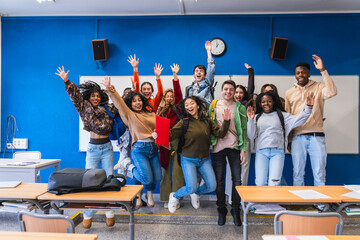 High school students jumping together in classroom
