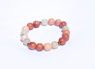 Bracelet with apricot jade, cream agate, and gold hematite on a white background