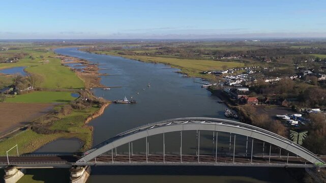 Dutch Train Crossing the Culemborg Bridge Over the Lek River