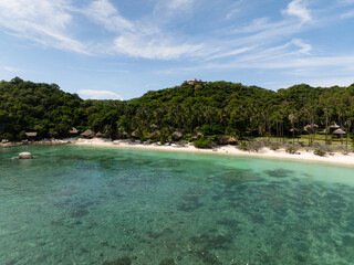 A peaceful tropical beach with lush greenery and clear turquoise lagoon. Koh Tao, Thailand.