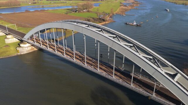 Dutch Train Crossing the Culemborg Bridge Over the Lek River