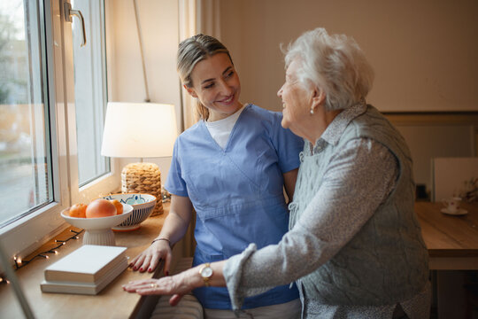 Caring healthcare worker visiting a senior patient at home.