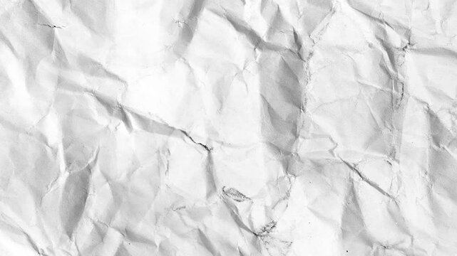 Crinkled paper texture This close-up captures the intricate textures of a piece of crinkled paper, offering a visual interplay of light and shadow, revealing a story of its own. 