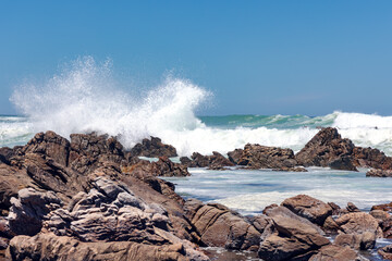 Large Indian Ocean waves and rocky coastline in Tsitsikamma, Garden Route National Park, Eastern Cape. South Africa	