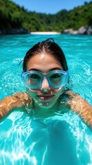 Naklejka premium Young woman swimming in crystal clear waters.