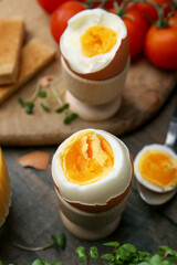 Soft boiled eggs on wooden table, closeup