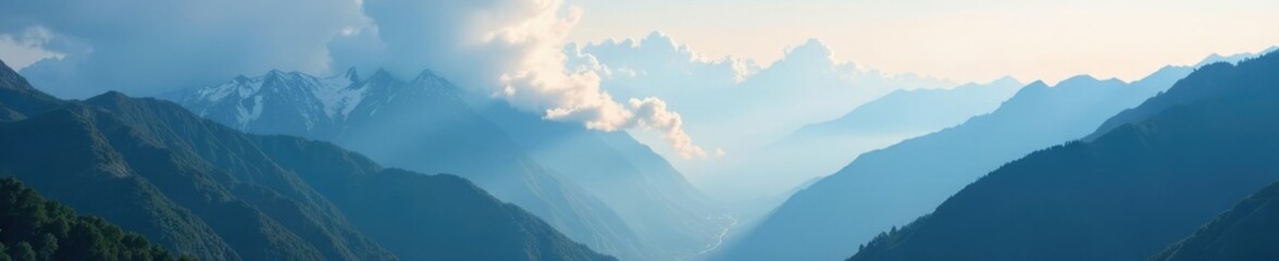 Fototapeta premium Dense clouds sprawl across mountain valley, softening rugged peaks, scenery, mist, fog