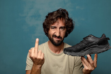 young adult bearded man with a sport shoe