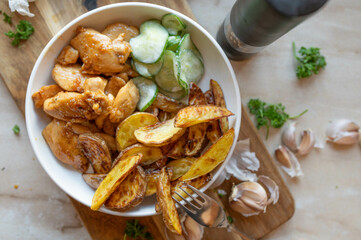 Chopped and pan fried chicken breast in a delicious honiy, butter, garlic sauce with potato wedges...