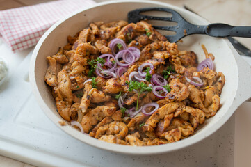 Pan fried chicken gyros fresh and homemade cooked. Made with chicken breast and served in a white...