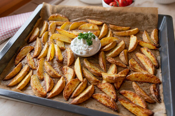 Homemade potato wedges with herb quark. Healthy gluten free meal