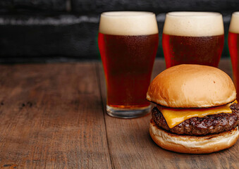 Delicious cheeseburger with a golden bun, accompanied by frothy amber beers on a rustic wooden table.