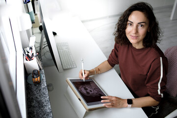 Female web designer using tablet at home