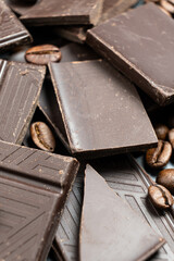 Dark chocolate pieces with coffee beans close-up.