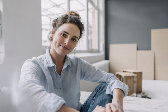 Portrait of smiling young woman relaxing at home