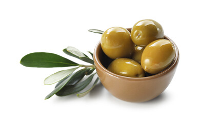 Delicious marinated green olives in bowl and leaves isolated on white