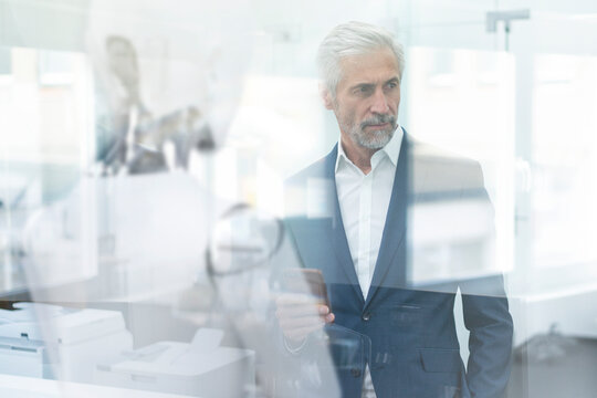 Businessman using digital device to control robot