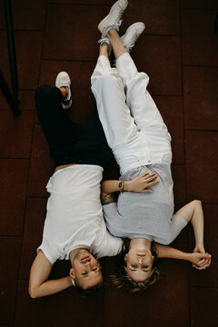 Young couple lying on the ground, from above