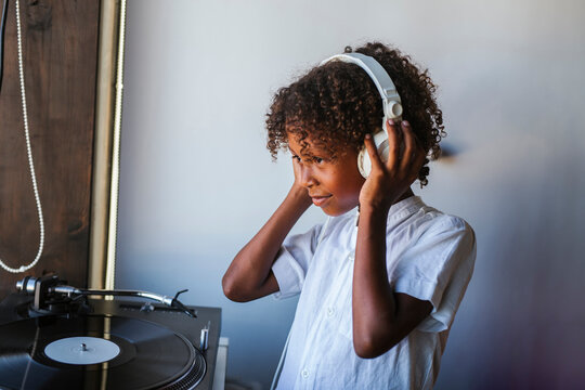 Young dj with headphones at the turntable