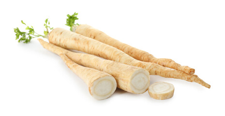 Whole and cut fresh parsley roots isolated on white