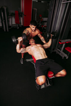 Muscular men training in gym