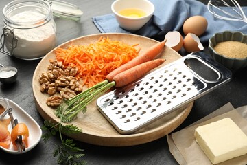 Different ingredients for making carrot cake on black table, closeup