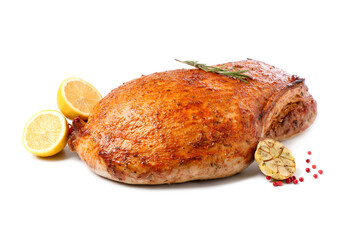 Piece of delicious baked turkey with lemon slices and spices isolated on white