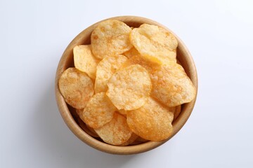 Tasty potato chips in bowl on white background, top view