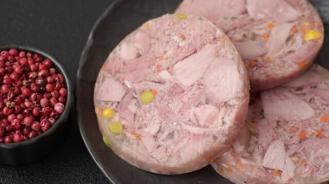 Homemade brawn with salt, spices, herbs and vegetables on a dark concrete background
