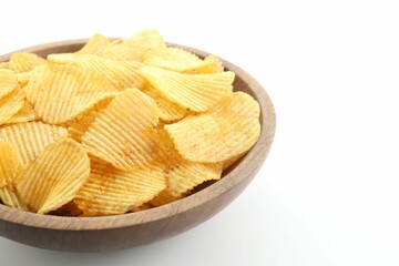 Tasty potato chips in bowl on white background, closeup. Space for text