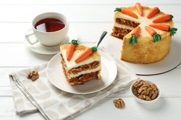 Delicious homemade carrot cake served on white wooden table