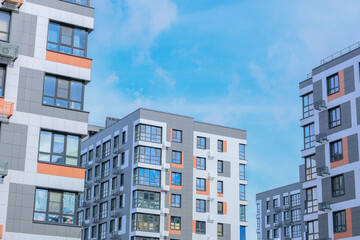 The concept of modern architecture, residential complex, apartment buildings for living. Multi-storey, apartment buildings of the residential complex in a single architecture in gray and white tones