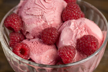 delicious sweet cold raspberry  flavored ice cream and ripe raspberries in a glass