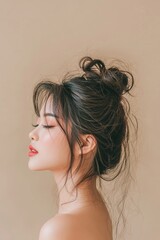 Fototapeta premium The portrait of a gorgeous Asian woman with pristine skin on a beige background represents the world of face care, facial treatments, and cosmetology, highlighting beauty and spa treatments for Asian