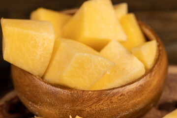 pumpkin pulp in a wooden bowl on the table