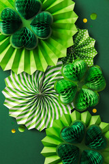Happy St. Patrick's Day concept. Flat lay composition with decorative paper fans, honeycomb clover...