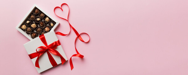 Delicious chocolate pralines in red box for Valentine's Day. Heart shaped box of chocolates top...