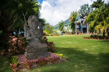 Buddha statues in botanical garden against cloudy sky at Saint Kitts And Nevis, Caribbean
