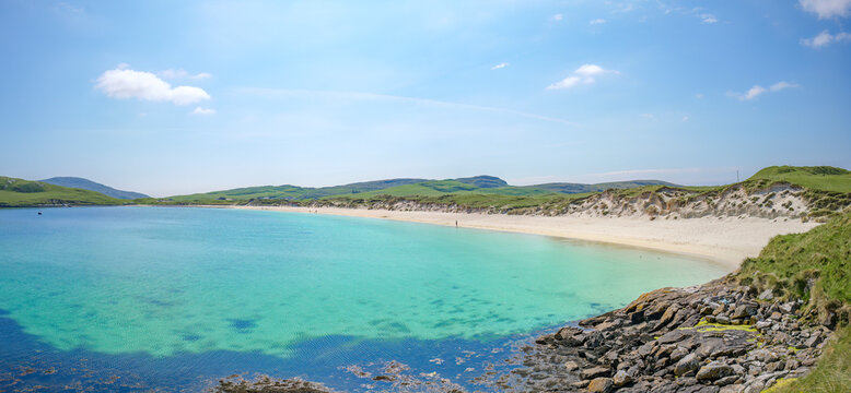 Scenic view of Traigh a Bhaigh beach on the Isle of Vatersay, Scotland, part of the Hebridean Way.