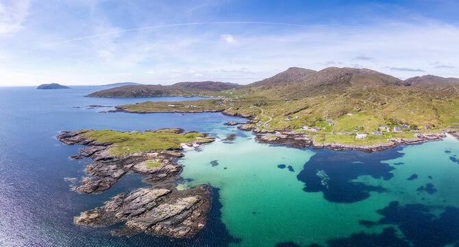Aerial view of the coastline of Earsairidh on the Isle of Barra, Scotland, showcasing a scenic and tranquil landscape.