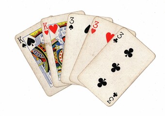 A poker hand of grubby old playing cards on a white background,.