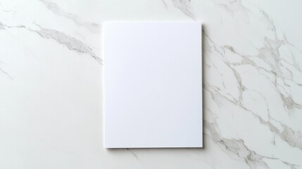 Blank white notebook on elegant marble desk, top view, minimalist style.