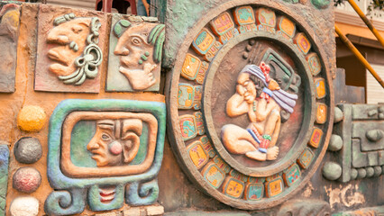 A close-up of intricate Mayan carvings, showcasing detailed craftsmanship and cultural heritage