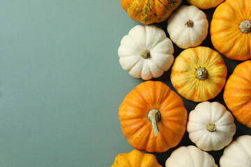 Beautiful autumn composition with pumpkins on a color background, top view