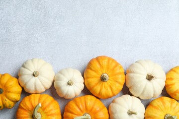 Beautiful autumn composition with pumpkins on a gray background, top view