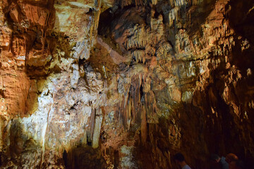 Underground limestone cave, stalactites, stalagmites, and geological formations. Geological and natural sculpture. Mineral deposits. Adventure travel, hiking and outdoor. Subterranean formations.
