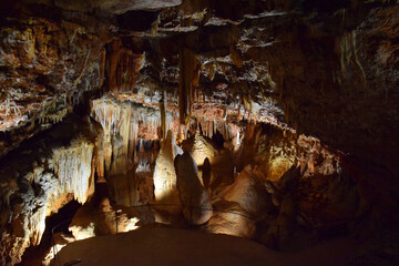 Underground limestone cave, stalactites, stalagmites, and geological formations. Geological and natural sculpture. Mineral deposits. Adventure travel, hiking and outdoor. Subterranean formations.