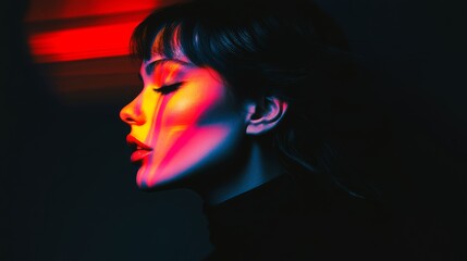 Naklejka premium Woman with red lips and black hair is the main focus of the image. The photo is in black and white and has a dramatic, moody feel to it. The woman's face is the only thing visible