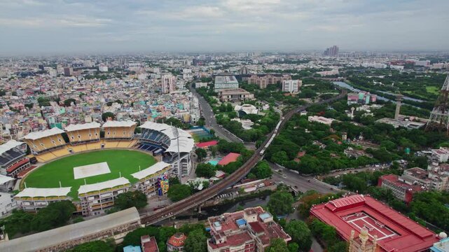 chepauk railway station with local train and M. A. Chidambaram Stadium at Victoria Hostel Road, PWD Estate, Chepauk, Triplicane, Chennai, Tamil Nadu, india. day time, push back, drone shot, 4k.
